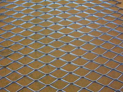 A piece of aluminum decorative expanded metal mesh on the ground.