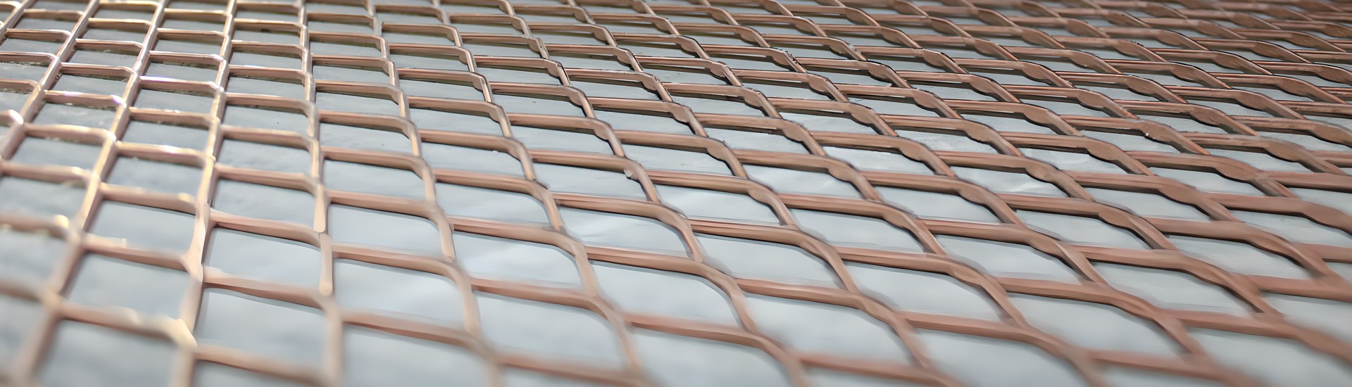 A copper expanded metal sheet laid flat on the floor