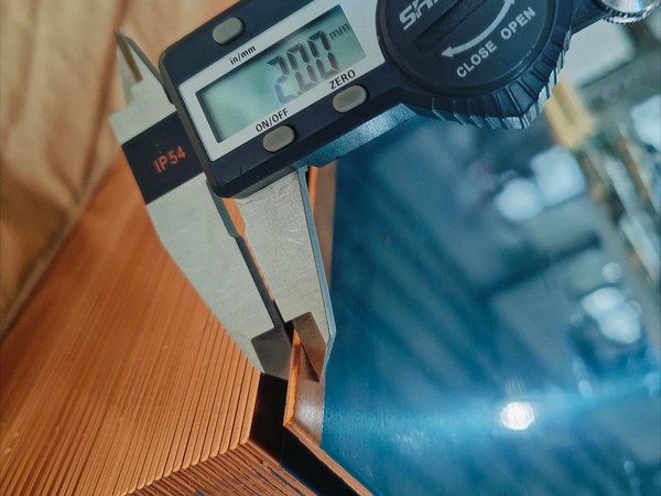 Measure the thickness of copper expanded metal mesh with a caliper.