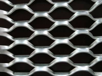 A hexagonal hole expanded metal mesh on the black background.