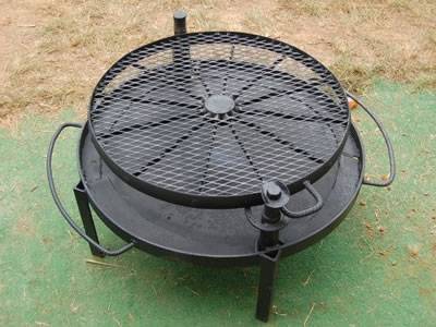 A round expanded metal barbecue grill on the cooker.