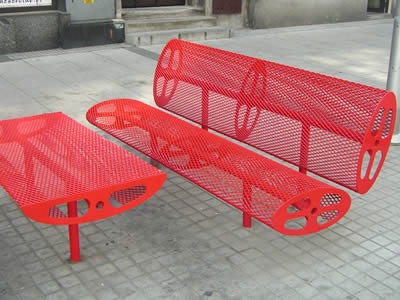 Expanded metal chair and table beside the street.