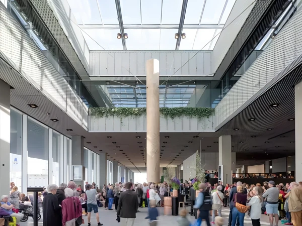 The interior of Dokk1 Library, decorated with expanded metal sheets, is filled with people.