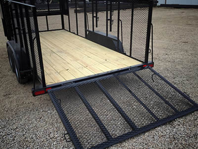 A utility trailer with slope and sides made of expanded metal.