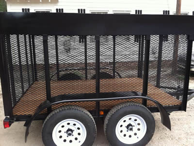 A black enclosed landscape trailer with expanded metal used to carry trash.