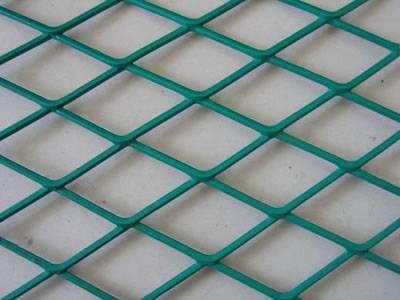 A piece of green PVC coated isolation fence on the gray background.