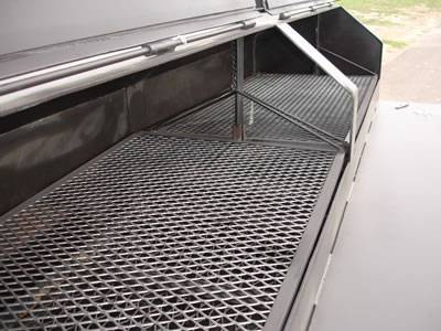 Two pieces of steel expanded metal barbecue grill in the backing car.